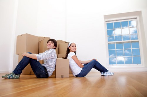 Professional movers handling furniture in a Highbury flat